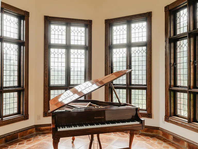 massive catskills ny castle for sale in sullivan county, light tudor style interior with baby grand piano