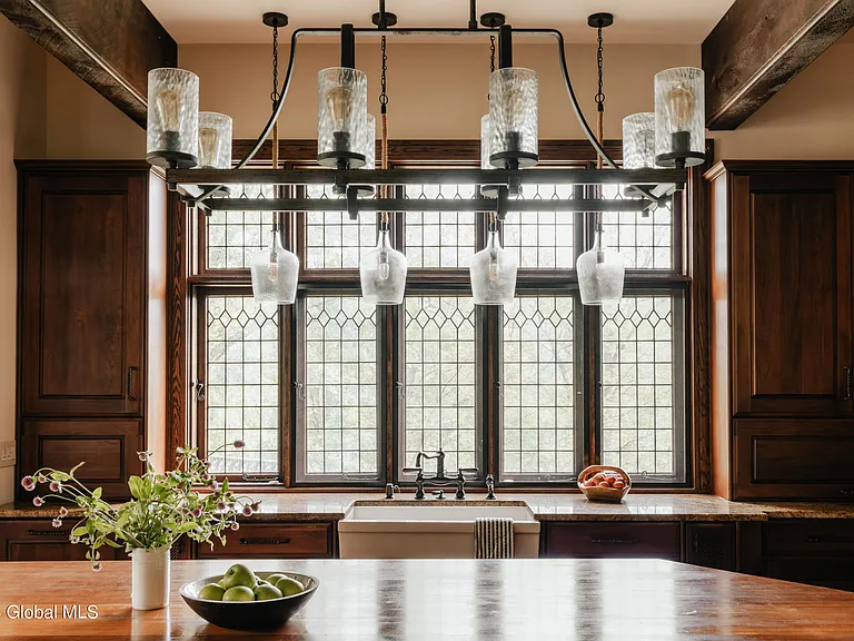 massive catskills ny castle for sale in sullivan county, tudor style kitchen with pendant lights and leaded glass windows