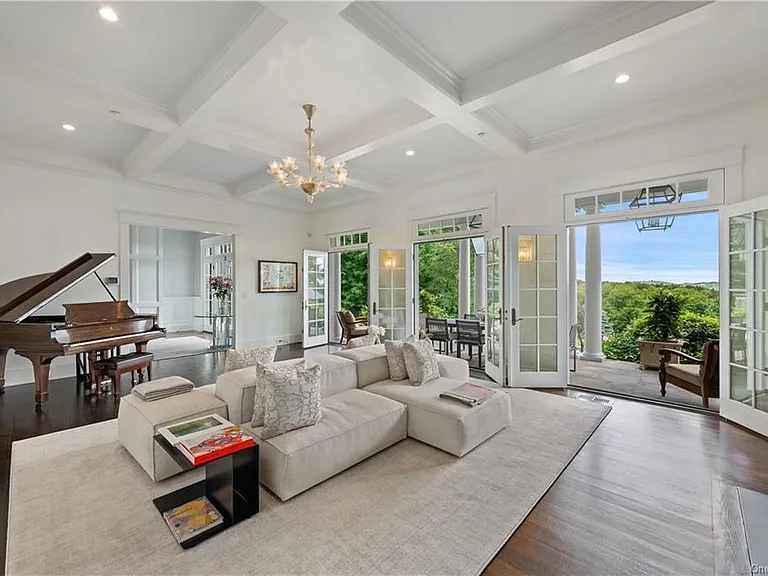 Westchester Mansion, interior of Happy Hill Farms in Bedford Corners New York with massive white double-sided sofa and tray ceilings