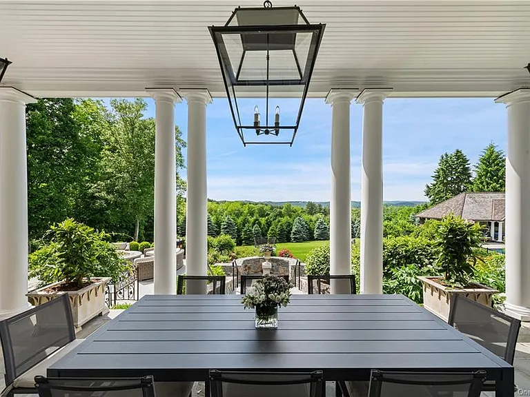 Westchester Mansion, exterior of Happy Hill Farms in Bedford Corners New York with outdoor dining space and outdoor chandeliers