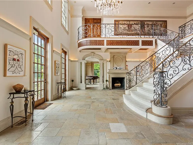 eclectic castle in new york, interior of the Salutation Castle replica with wrought iron railings throughout and massive estate staircases