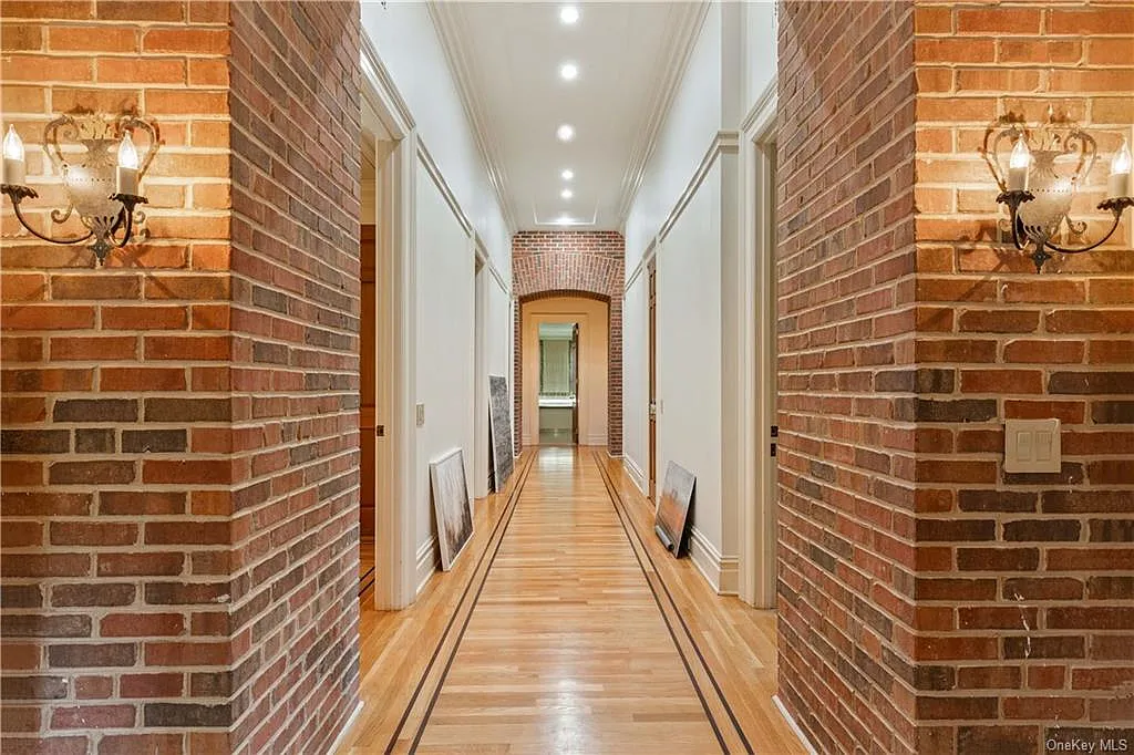 eclectic castle in new york, interior of the Salutation Castle replica with long brick hallways leading to rooms