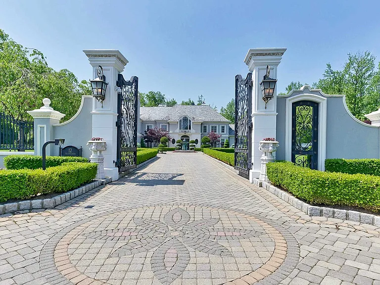 maximalist NJ mansion, 12 The Esplanade in Alpine New Jersey exterior gates and massive paver driveway