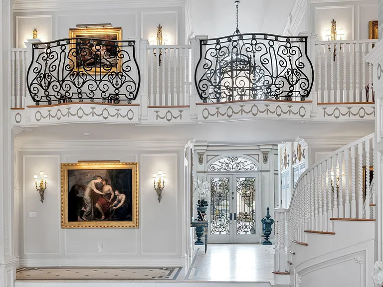 maximalist NJ mansion, 12 The Esplanade in Alpine New Jersey interior marble hallway with mosaic tile and wrought iron railings