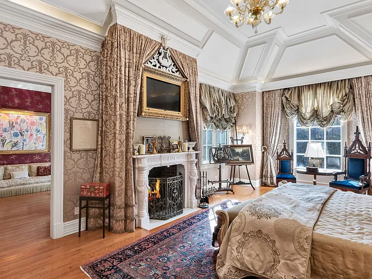 maximalist NJ mansion, 12 The Esplanade in Alpine New Jersey interior master bedroom with massive tray ceilings and canopy bed and fireplace