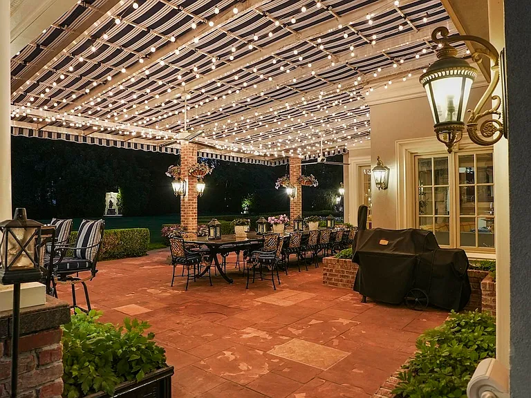 maximalist NJ mansion, 12 The Esplanade in Alpine New Jersey exterior patio with string lights