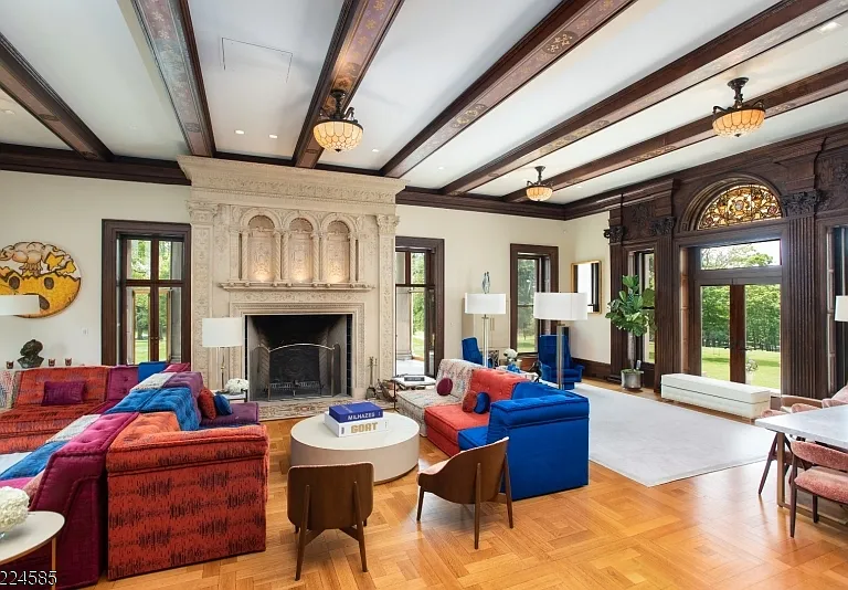 19th-Century Castle in New Jersey, exterior of a massive stone castle in Bernardsville NJ with massive living space dark wood beams with modern furniture