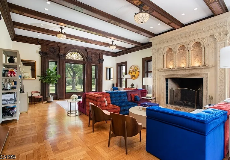 19th-Century Castle in New Jersey, exterior of a massive stone castle in Bernardsville NJ with massive living space dark wood beams with modern furniture