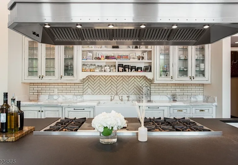 19th-Century Castle in New Jersey, exterior of a massive stone castle in Bernardsville NJ with a modern stainless steel and white kitchen