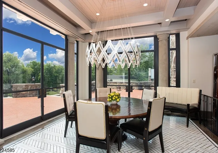 19th-Century Castle in New Jersey, exterior of a massive stone castle in Bernardsville NJ with a modern stainless steel and white kitchen and glass paneled breakfast nook