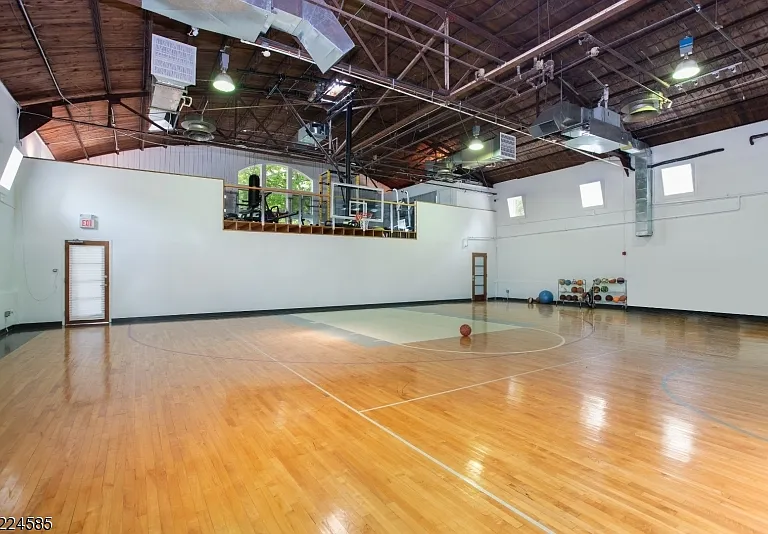 19th-Century Castle in New Jersey, exterior of a massive stone castle in Bernardsville NJ with a large carriage house and guest space with private indoor basketball court