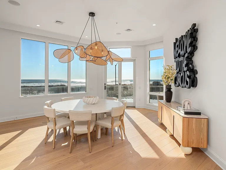 Jersey Shore Beachfront Mansion, beachy modern interior with an imported marble open kitchen design and breakfast nook overlooking the atlantic ocean