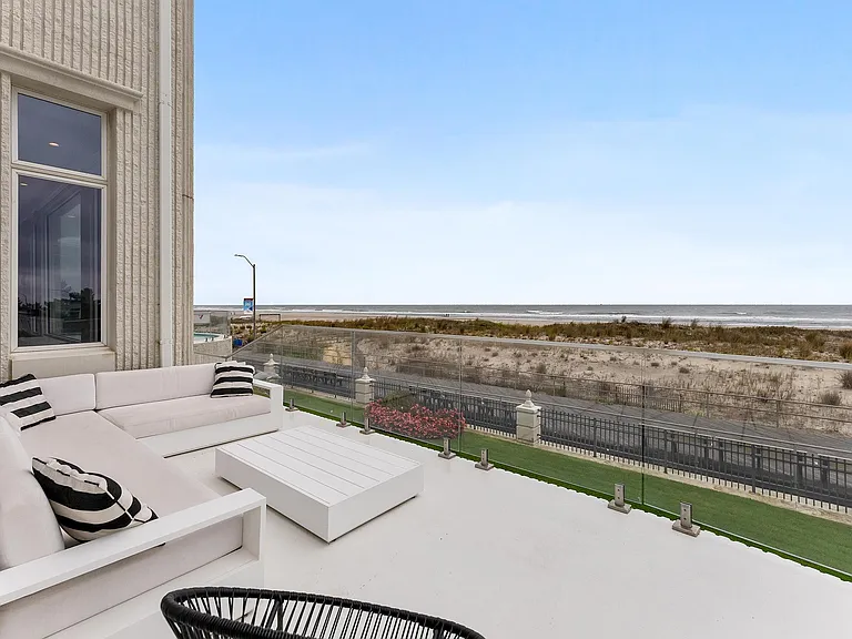 Jersey Shore Beachfront Mansion, beachy modern interior with an exit leading to the atlantic ocean beach in ventnor city