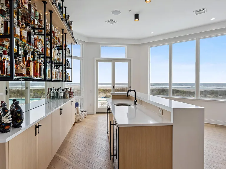 Jersey Shore Beachfront Mansion, beachy modern interior with an imported marble open kitchen design massive home bar overlooking the atlantic ocean beach