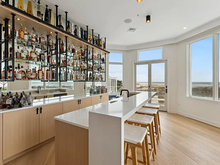 Jersey Shore Beachfront Mansion, beachy modern interior with an imported marble open kitchen design massive home bar overlooking the atlantic ocean beach