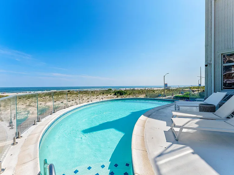 Jersey Shore Beachfront Mansion, beachy modern interior with a kidney shaped pool leading to the atlantic ocean beach in ventnor city