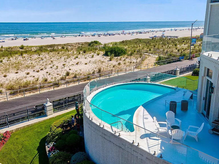 Jersey Shore Beachfront Mansion, beachy modern interior with a kidney shaped pool leading to the atlantic ocean beach in ventnor city