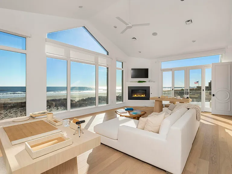 Jersey Shore Beachfront Mansion, beachy modern interior with an imported marble open kitchen design massive living room with vaulted ceilings overlooking the atlantic ocean