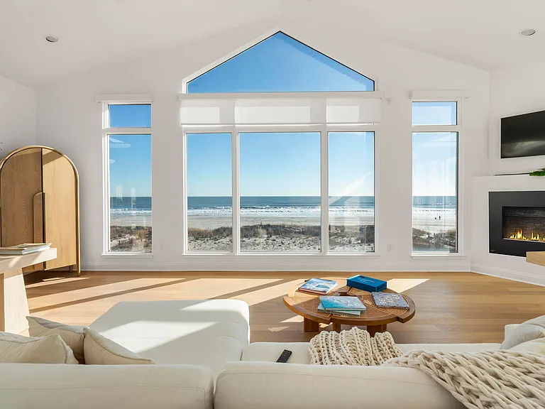 Jersey Shore Beachfront Mansion, beachy modern interior with an imported marble open kitchen design massive living room with vaulted ceilings overlooking the atlantic ocean