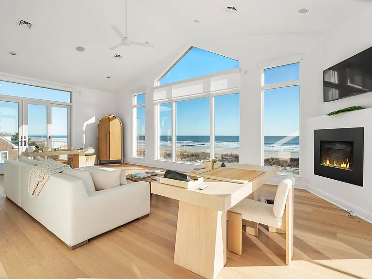 Jersey Shore Beachfront Mansion, beachy modern interior with an imported marble open kitchen design massive living room with vaulted ceilings overlooking the atlantic ocean