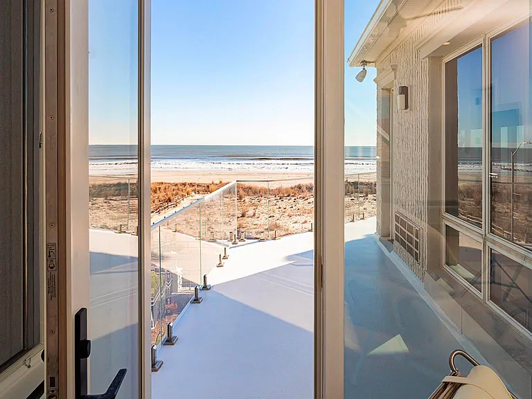 Jersey Shore Beachfront Mansion, beachy modern interior with an exit leading to the atlantic ocean beach in ventnor city