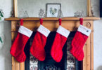 stocking stuffer ideas for men, red christmas stockings hung on the fireplace mantle