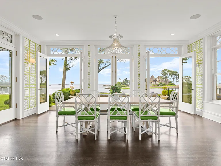 most expensive home in Connecticut, Greenwich mansion interior with modern classic interior all white and green dining space overlooking the long island sound