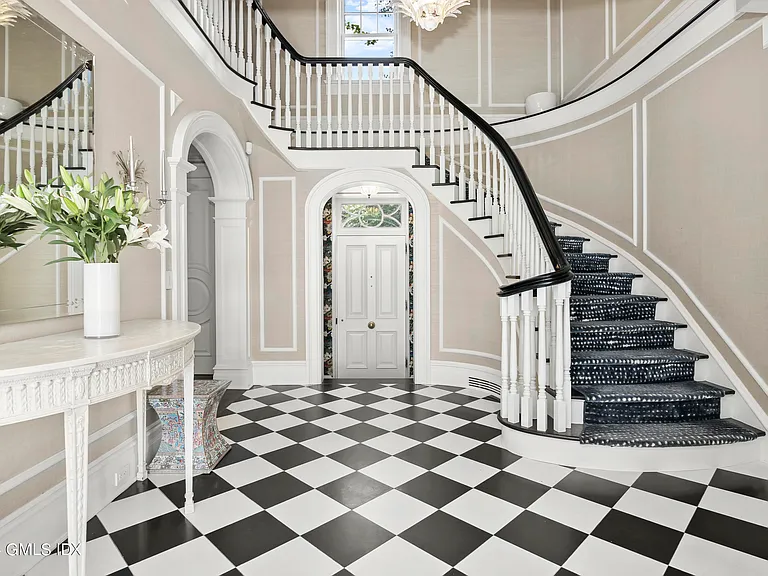 most expensive home in Connecticut, Greenwich mansion interior with modern classic interior with a massive staircase and vaulted ceilings overlooking the long island sound