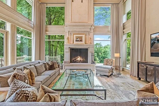 interior of a posh modern saddle river mansion in New Jersey's Bergen County, large modern living room with vaulted ceilings and beige finishes