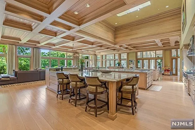 interior of a posh modern saddle river mansion in New Jersey's Bergen County, massive kitchen with 18-foot islands and hand-crafted ceilings with tray finishing