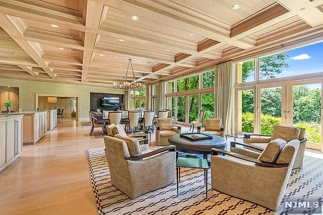 interior of a posh modern saddle river mansion in New Jersey's Bergen County, massive kitchen with 18-foot islands and hand-crafted ceilings with tray finishing