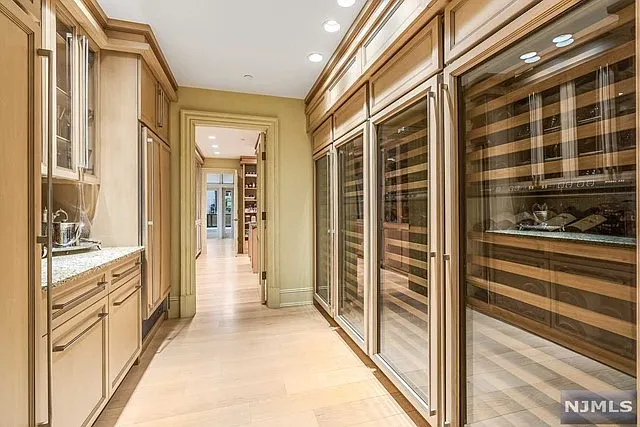 interior of a posh modern saddle river mansion in New Jersey's Bergen County, massive home wine cellar with space for thousands of bottles