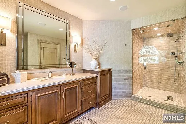 interior of a posh modern saddle river mansion in New Jersey's Bergen County, large master bathroom with soaking tub and marble finishes