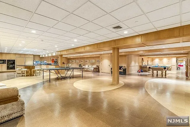 interior of a posh modern saddle river mansion in New Jersey's Bergen County, massive indoor entertainment space with bar and game room