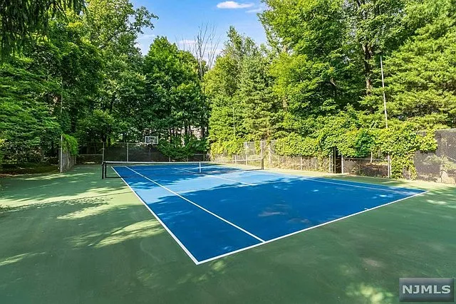 interior of a posh modern saddle river mansion in New Jersey's Bergen County, massive tennis court