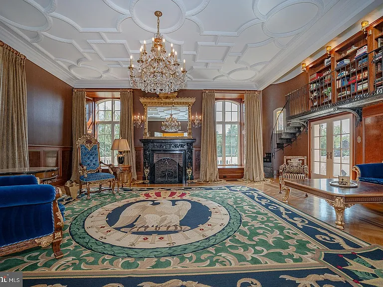 Massive Pennsylvania Castle in Gladwyne, formal living room and seating area with classic velvet furniture wood bookshelves and gilded details