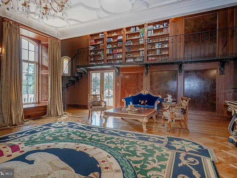 Massive Pennsylvania Castle in Gladwyne, formal living room and seating area with classic velvet furniture wood bookselves and gilded details