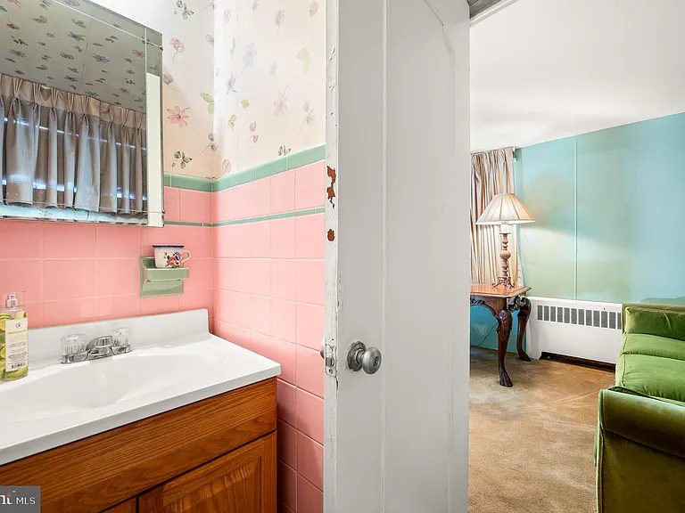 Philly home of boxer Muhammad Ali and family, midcentury modern home interior with original pink tile bathroom in Morris Park Philadelphia