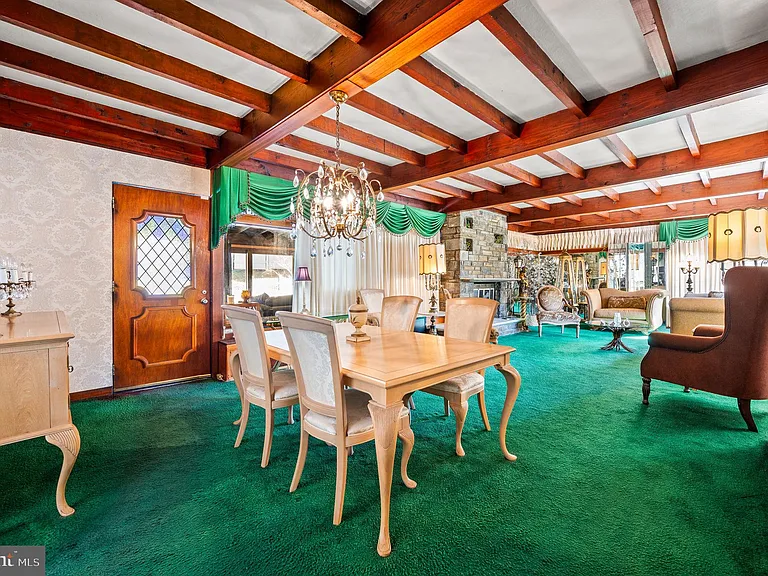 Philly home of boxer Muhammad Ali and family, midcentury modern home interior with green carpet and vaulted ceilings in Morris Park Philadelphia