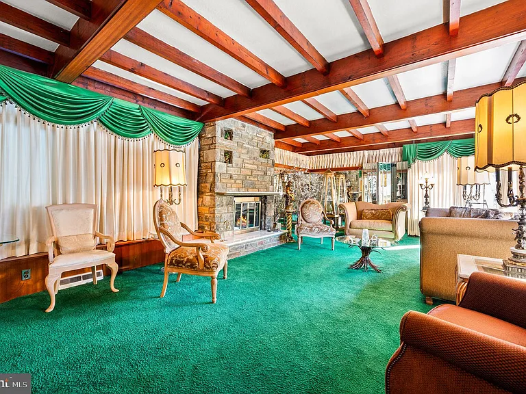 Philly home of boxer Muhammad Ali and family, midcentury modern home interior with green carpet and vaulted ceilings in Morris Park Philadelphia