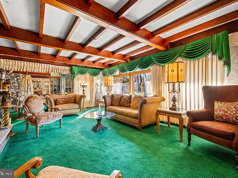 Philly home of boxer Muhammad Ali and family, midcentury modern home interior with green carpet and vaulted ceilings in Morris Park Philadelphia