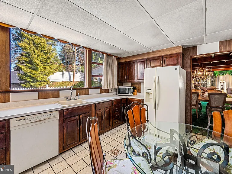 Philly home of boxer Muhammad Ali and family, midcentury modern home interior with wood paneled kitchen in Morris Park Philadelphia