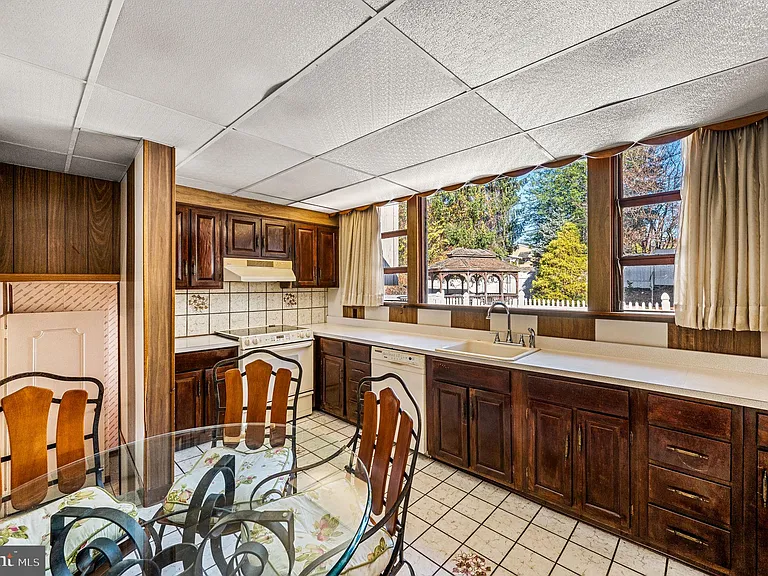 Philly home of boxer Muhammad Ali and family, midcentury modern home interior with wood paneled kitchen in Morris Park Philadelphia