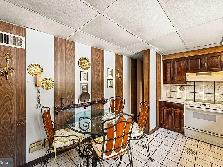 Philly home of boxer Muhammad Ali and family, midcentury modern home interior with wood paneled kitchen in Morris Park Philadelphia