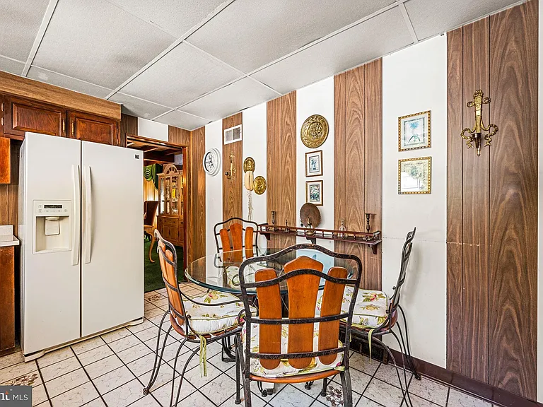 Philly home of boxer Muhammad Ali and family, midcentury modern home interior with wood paneled kitchen in Morris Park Philadelphia