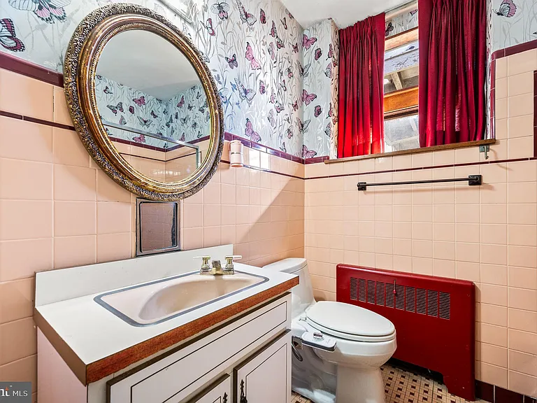 Philly home of boxer Muhammad Ali and family, midcentury modern home interior with original pink tile bathroom in Morris Park Philadelphia