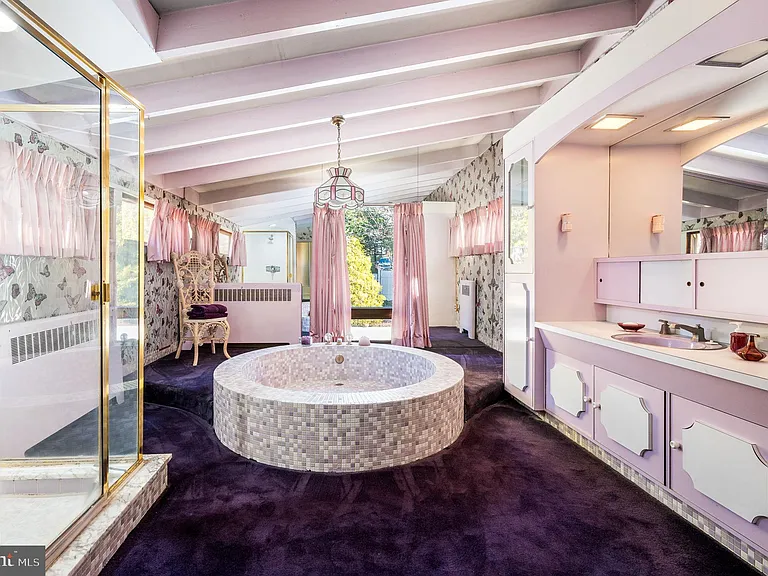 Philly home of boxer Muhammad Ali and family, midcentury modern home interior with purple and lavender master bathroom complete with a circular bathtub in Morris Park Philadelphia