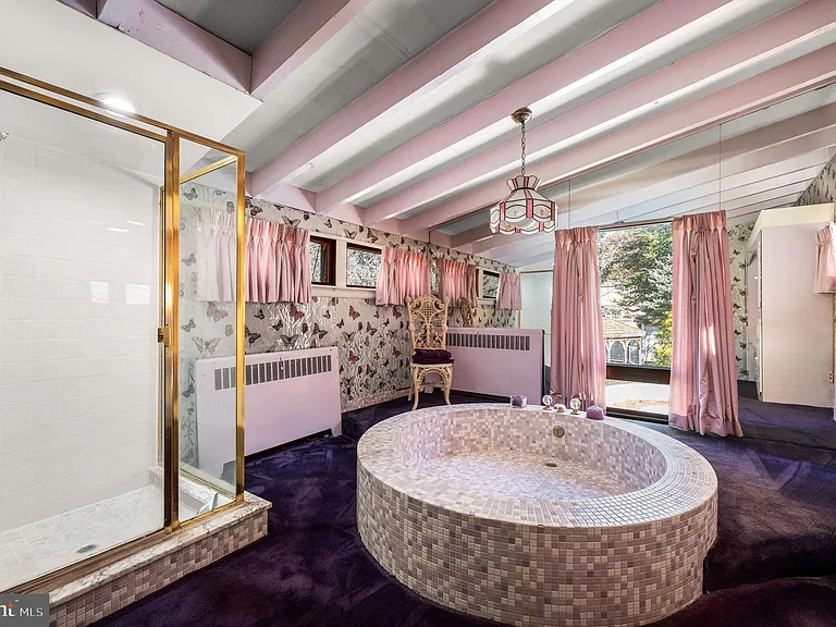 Philly home of boxer Muhammad Ali and family, midcentury modern home interior with purple and lavender master bathroom complete with a circular bathtub in Morris Park Philadelphia