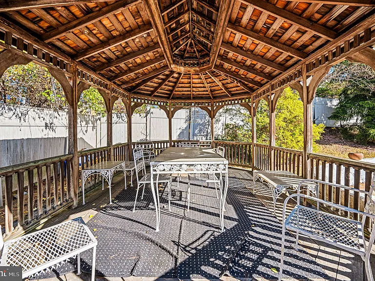 Philly home of boxer Muhammad Ali and family, midcentury modern home exterior with gazebo overlooking ground pool in Morris Park Philadelphia