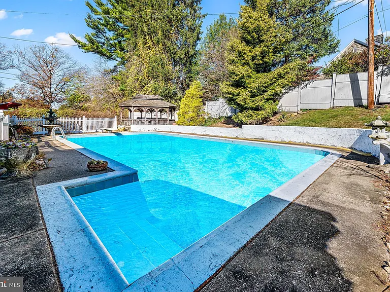 Philly home of boxer Muhammad Ali and family, midcentury modern home exterior with in ground pool in Morris Park Philadelphia